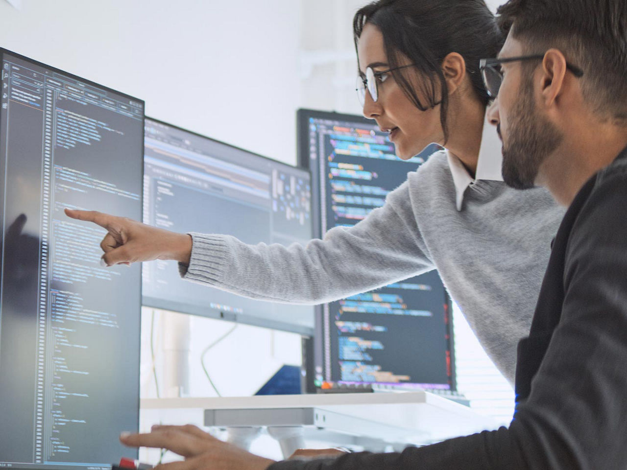 Developers view data on a monitor.