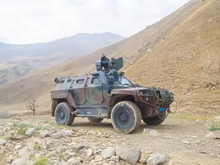 Defining and Advancing Rugged, Reliable Connectivity in Aerospace and Defense Camo Military Vehicle 