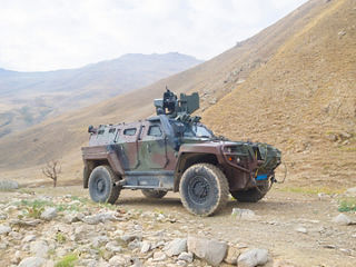 Defining and Advancing Rugged, Reliable Connectivity in Aerospace and Defense Camo Military Vehicle 