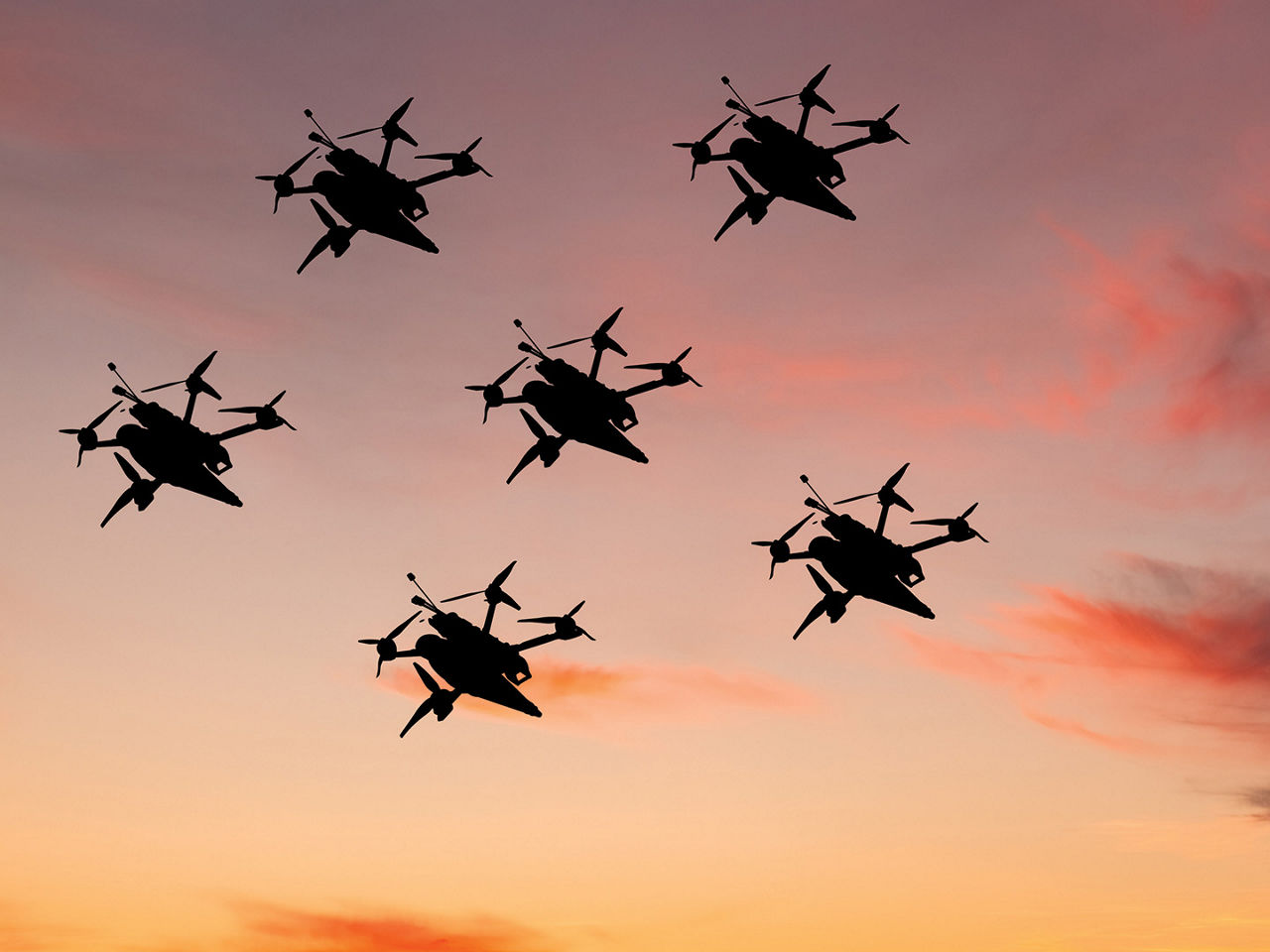 Small, lightweight drones flying in the sky.