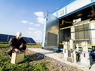 A technician maintains a battery energy storage system. 