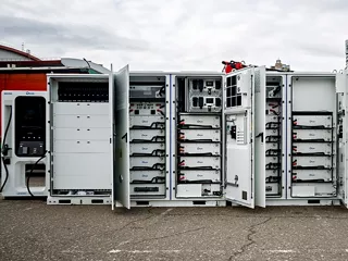 Energy storage system with battery containers and electrical components.