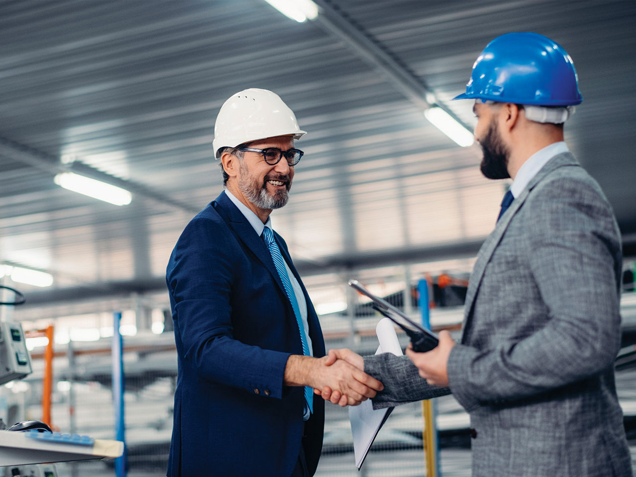 Men shaking hands in a production facility 