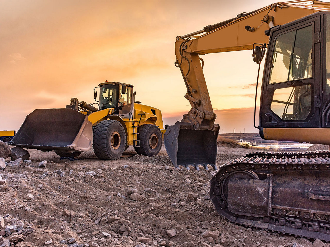 Construction excavators in a high-debris environment, requiring IP69K-rated sealed interconnects for reliability.
