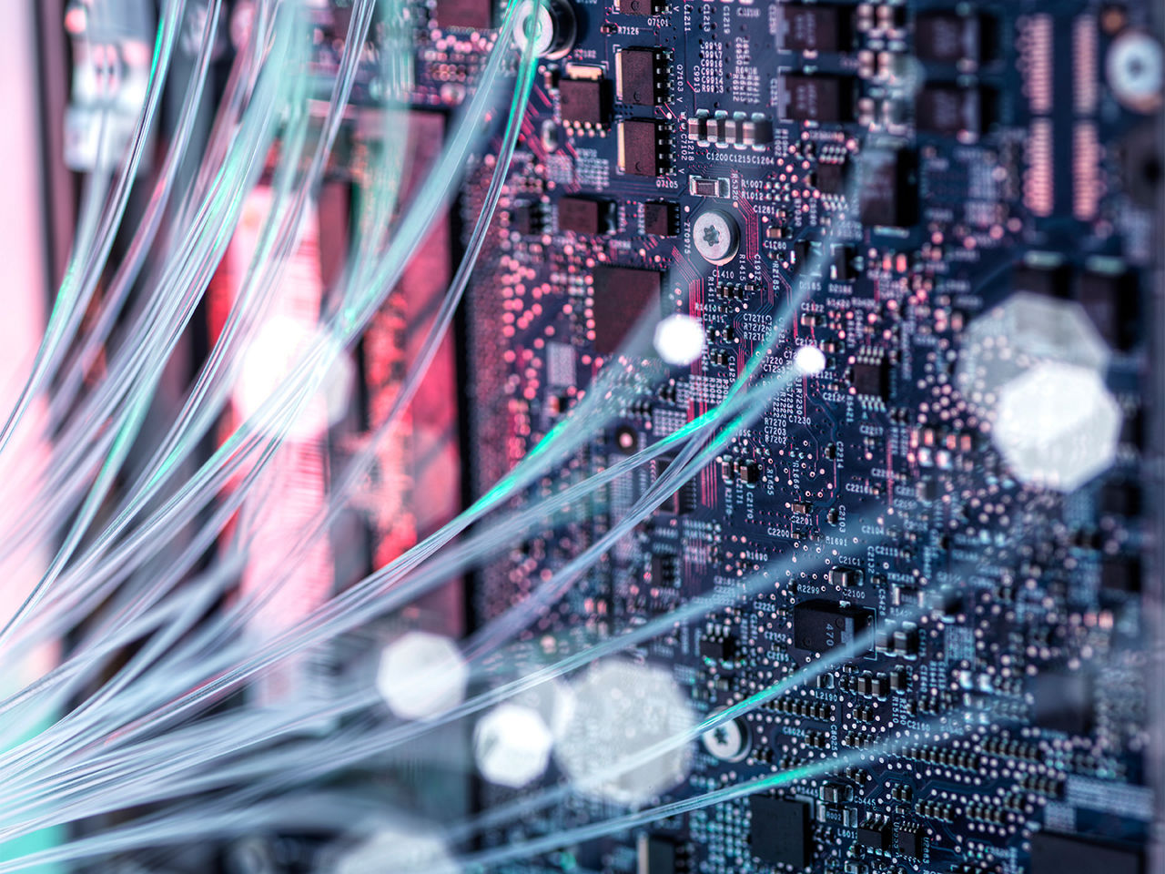 Fiber optic cables against computer mother board. 