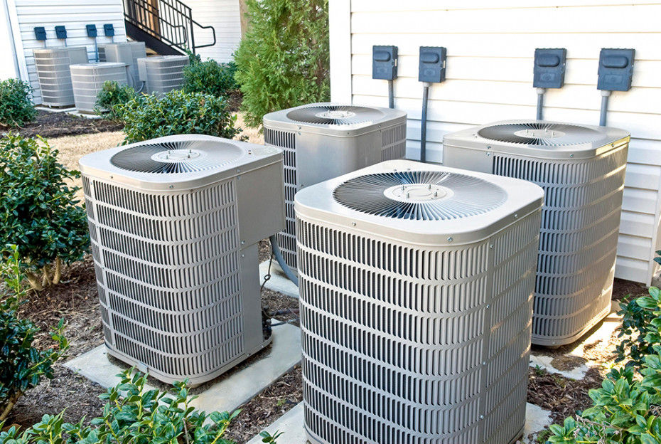 Four HVAC units exposed to natural elements 