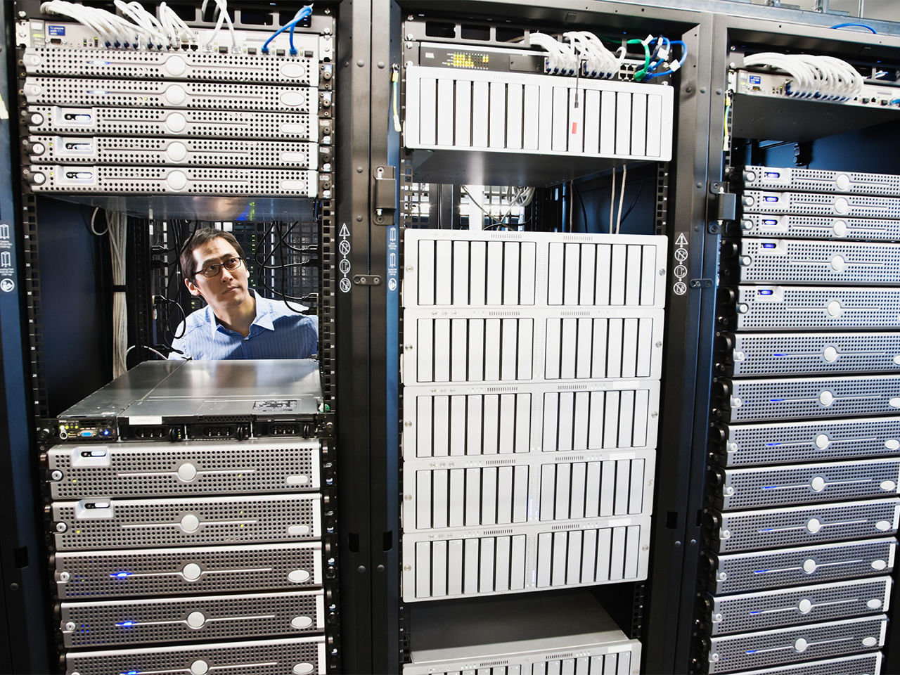 Data center technicians installing fiber optic connectors. 