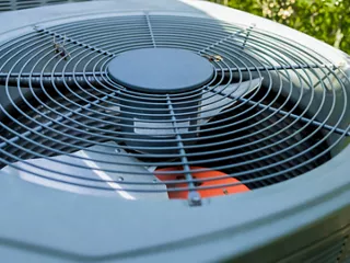 Close-up of an outdoor HVAC unit fan system. 