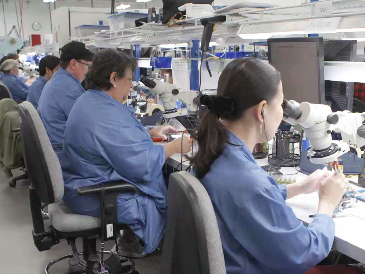 Workers assembling components on the AirBorn factory production line.  