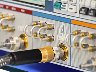Heavy-duty coaxial cables connect to RF test and measurement equipment.