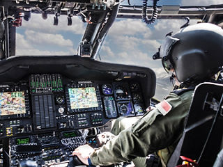 Army helicopter pilot flying a helicopter.