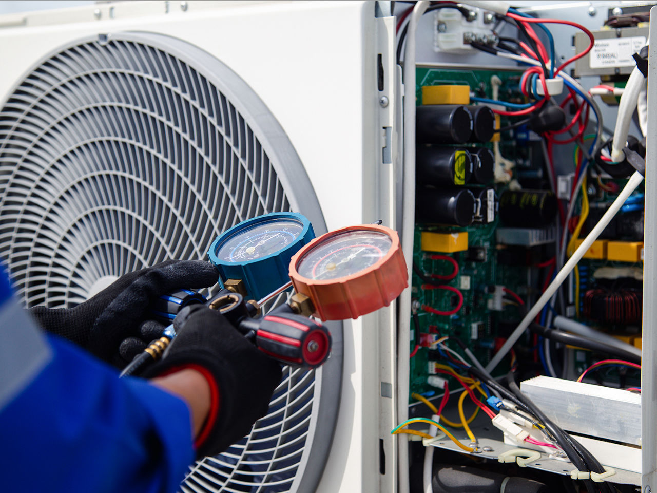 Gloved technician working on HVAC maintenance 