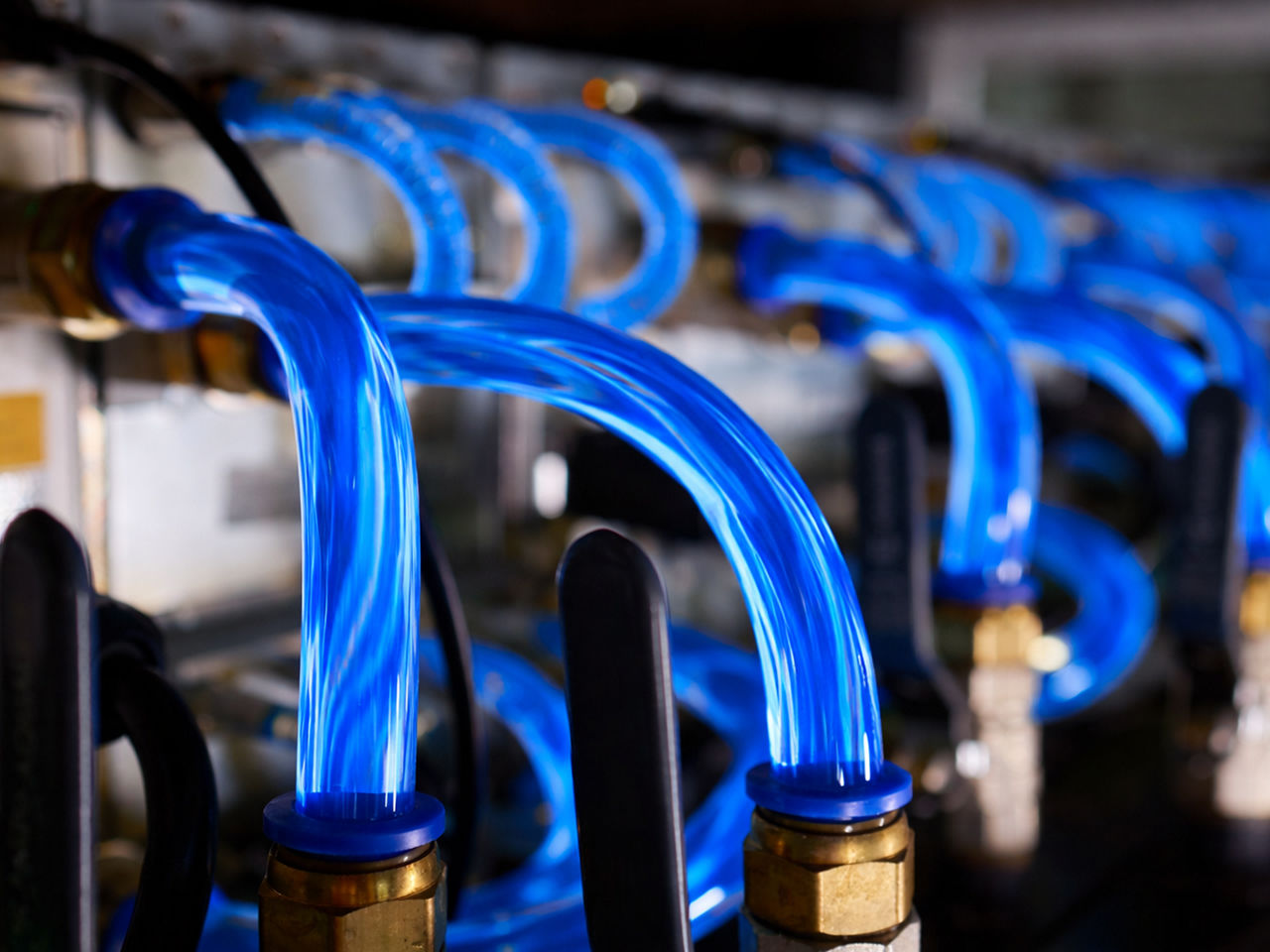 Liquid cooling tubes attached to server racks in a data center.