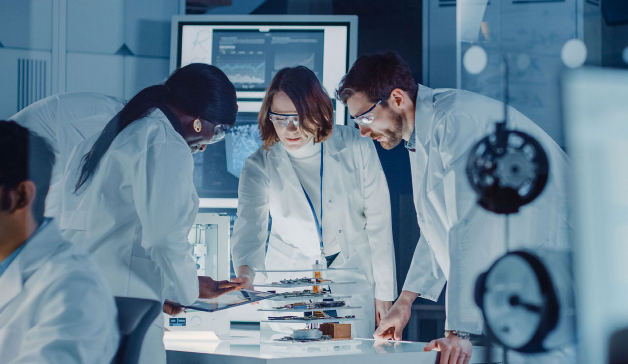 In Technology Research Laboratory: Diverse Team of Industrial Scientists, Engineers, Developers Work with Digital Whiteboard Showing Engine Blueprints, Efficiency Calculated by Neural Network