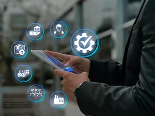 Person using tablet to manage digital supply chain operations. 