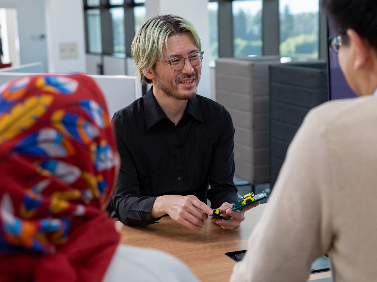 Kota Kamezaki, Group Product Manager at Molex, collaborates on connector development for the Quad-Row micro connector in an office setting. 