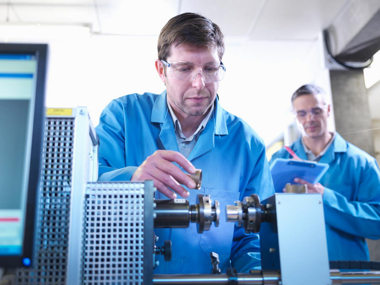 Engineers conduct accelerated reliability testing on a connector in a laboratory setting.