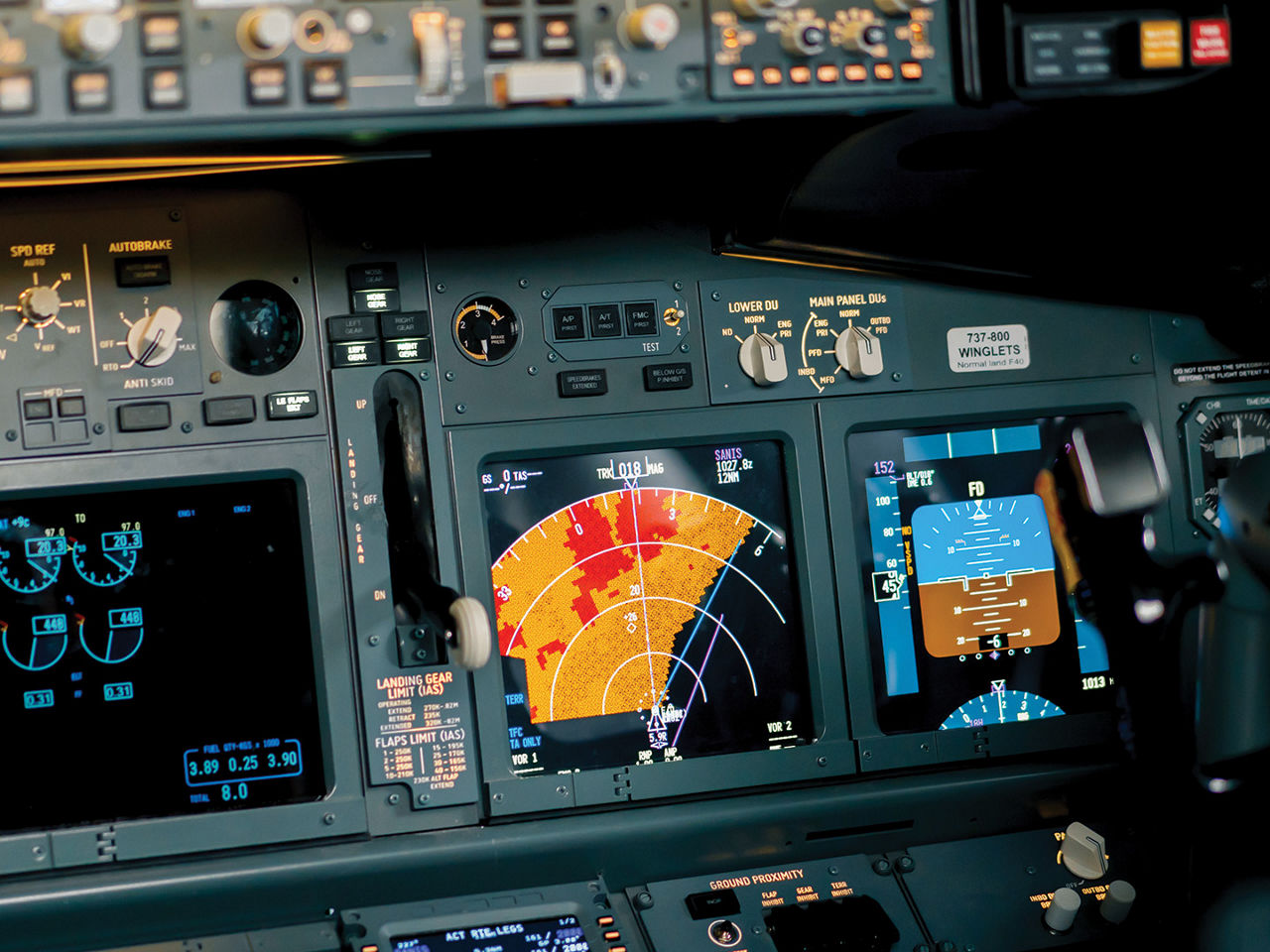 The radar control and navigation panel in the cockpit of a commercial aircraft.