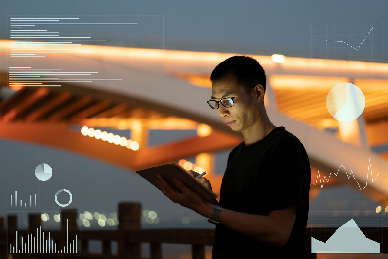 Young Asian man viewing a data chart