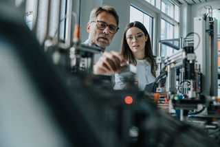 Two scientists in machine engineering lab