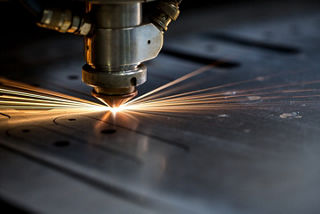Cutting of metal. Sparks fly from laser, close-up