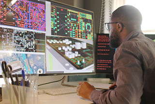 An electrical engineer designs a PCB choosing components from integrated tools.