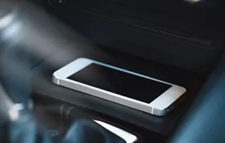 Mobile phone charging via an automotive wireless charging module.